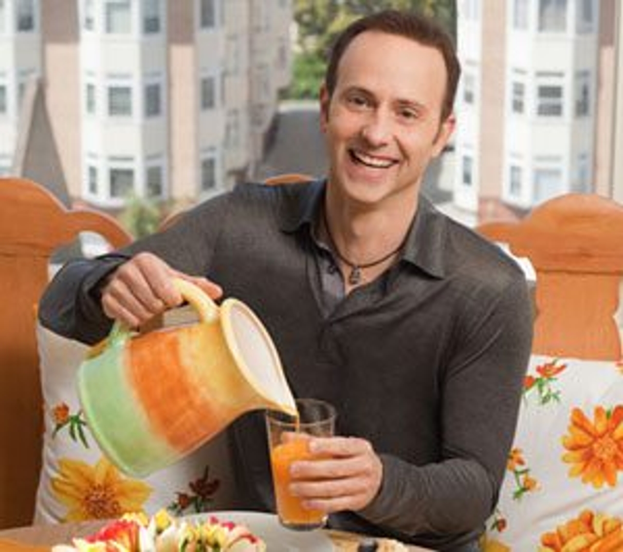 Brian Boitano cooks for guests at his San Francisco home, where the juice, pitcher and floral pillows all match (Photo courtesy of the Food Network)