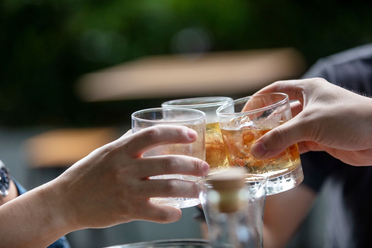 Three people toasting with scotch wisky