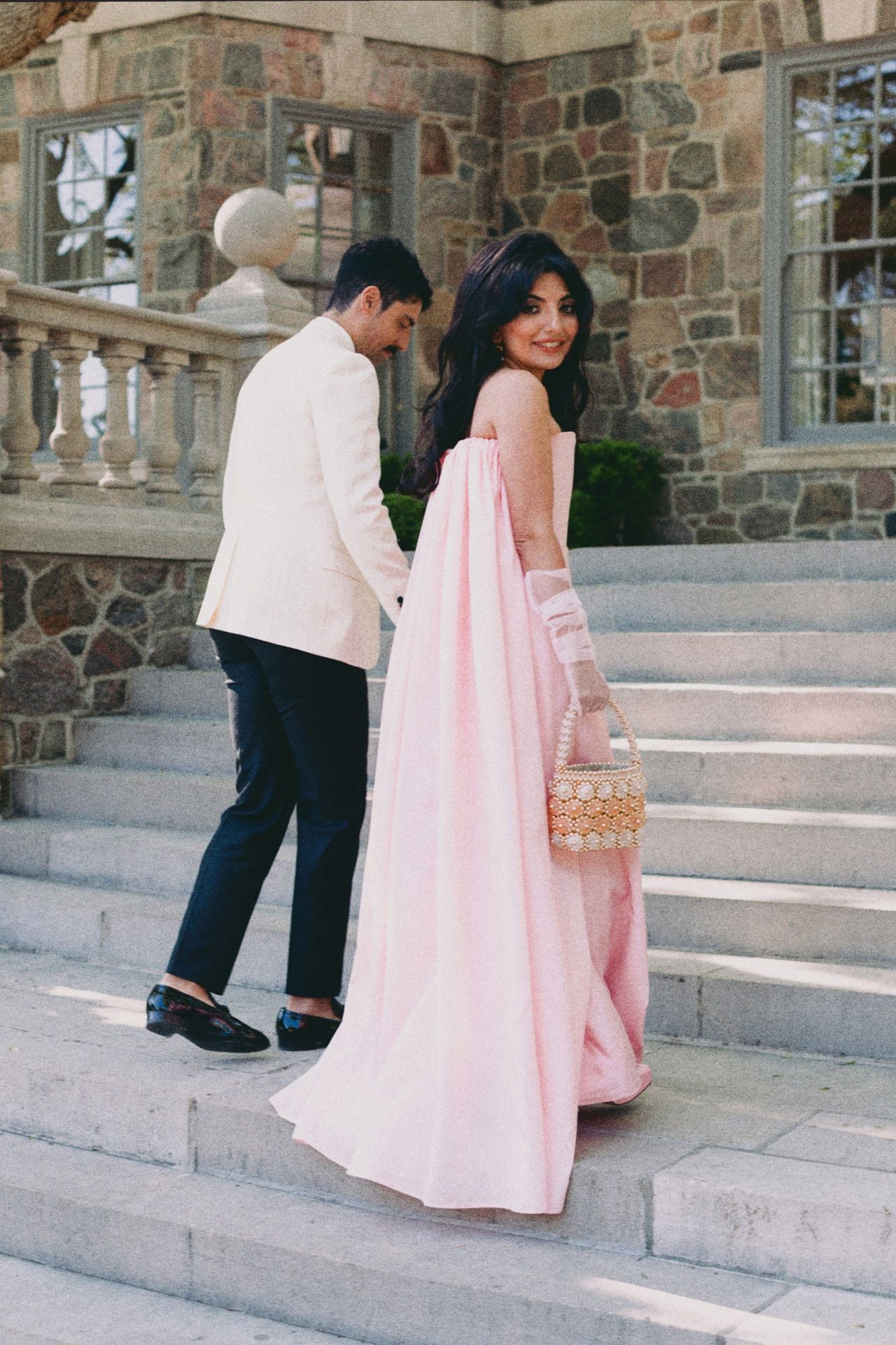Roya and Mani walking up the stone steps at Graydon hall