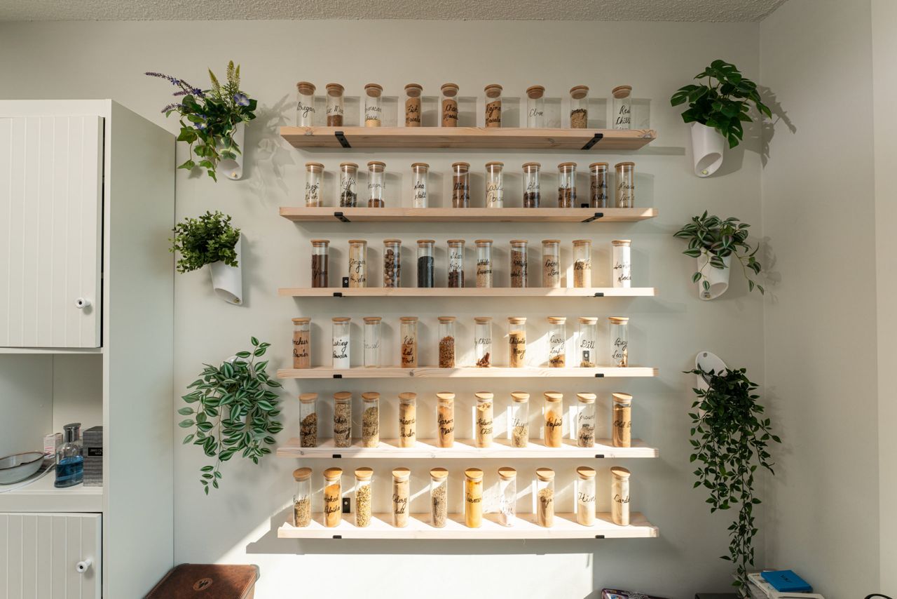 Ravneet's extensive spice collection is displayed on shelves mounted on the walls of his condo