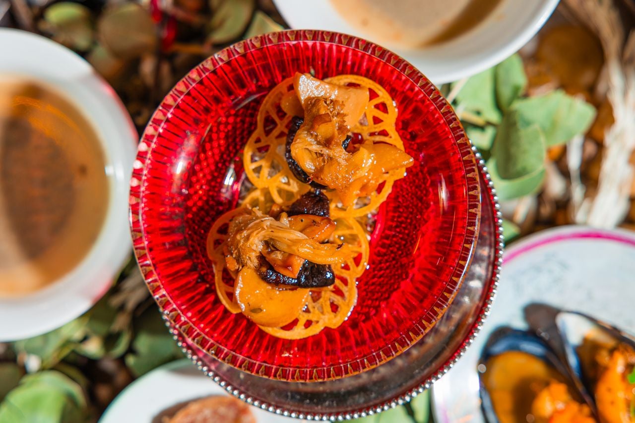 A small dish full of orange mushrooms