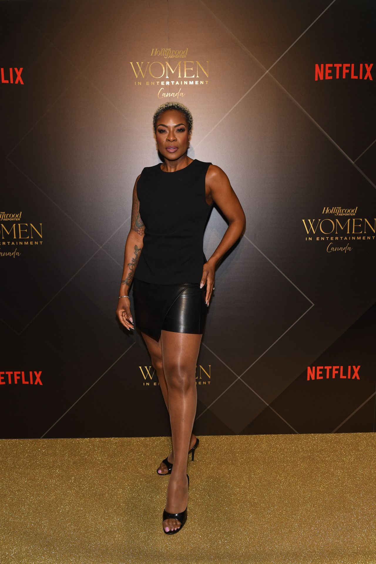 Jully Black strikes a pose on the gold carpet at the Hollywood Reporter Women in Entertainment Canada gala