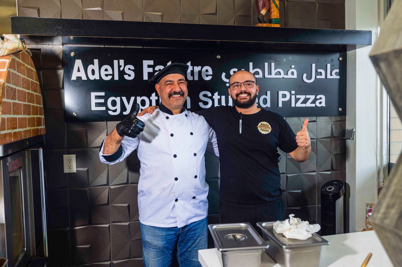 The chef and owners of Adel's Fatatre pose in their restaurant