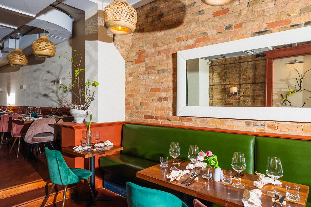 Banquette seating in the front dining room of Radici Project