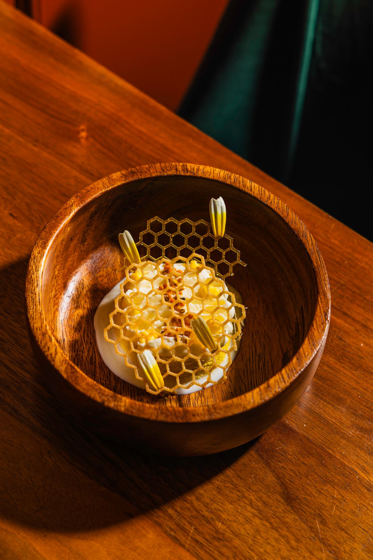 A sponge cake, layered with milk, chamomile custard and chamomile gel, sits beneath a delicate pollen-studded tuile