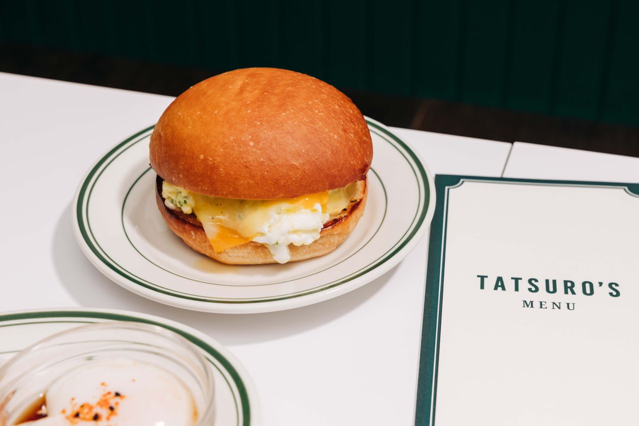 A breakfast sandwich with nori scrambled eggs and marble cheese on a shokupan bun