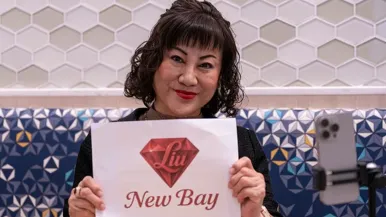 The Chinese billionaire behind the Bay's acquisition says she may move to Toronto