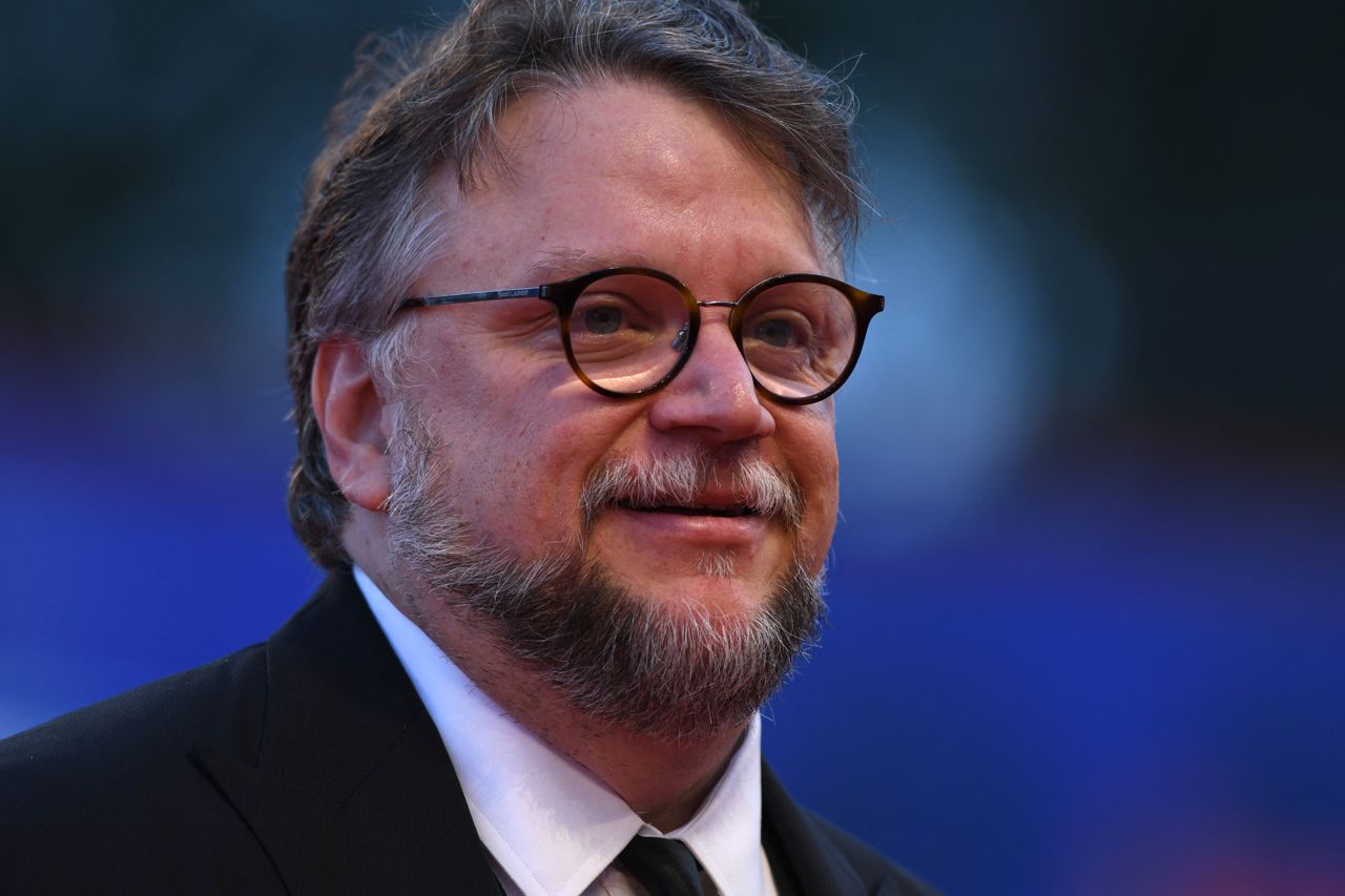 A close-up of filmmaker Guillermo del Toronto against a blurry blue background