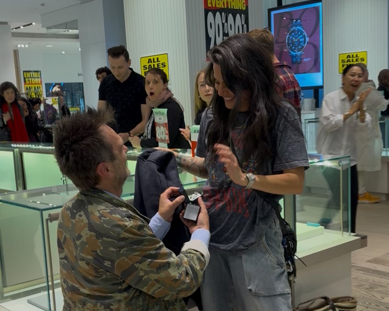 Rudin proposes to Rebecca in a The Bay department store, while onlookers observed, shocked.