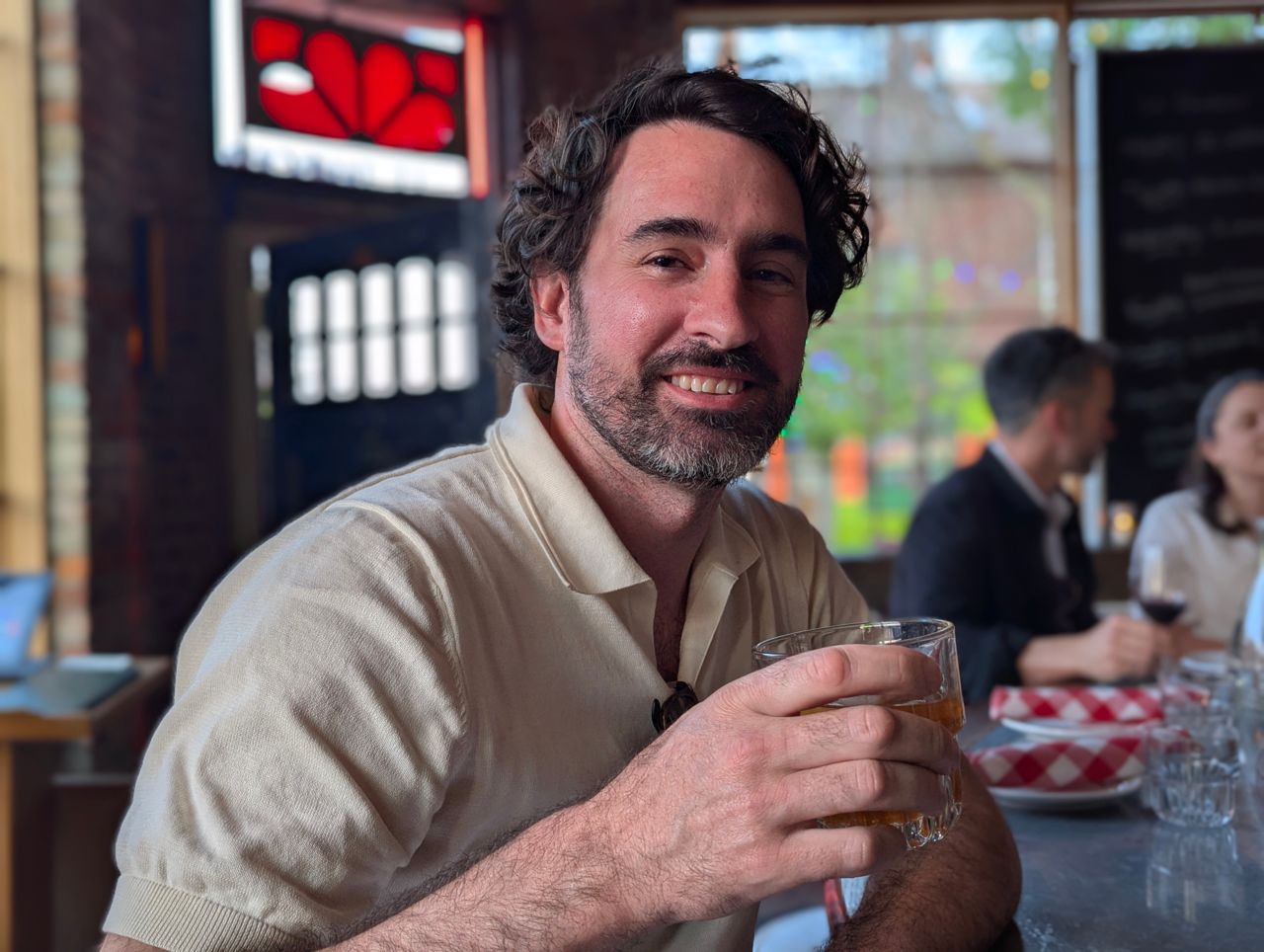 Chef Eric Robertson holds a cocktail at the bar inside Le Tambour Tavern, a restaurant in Hamilton