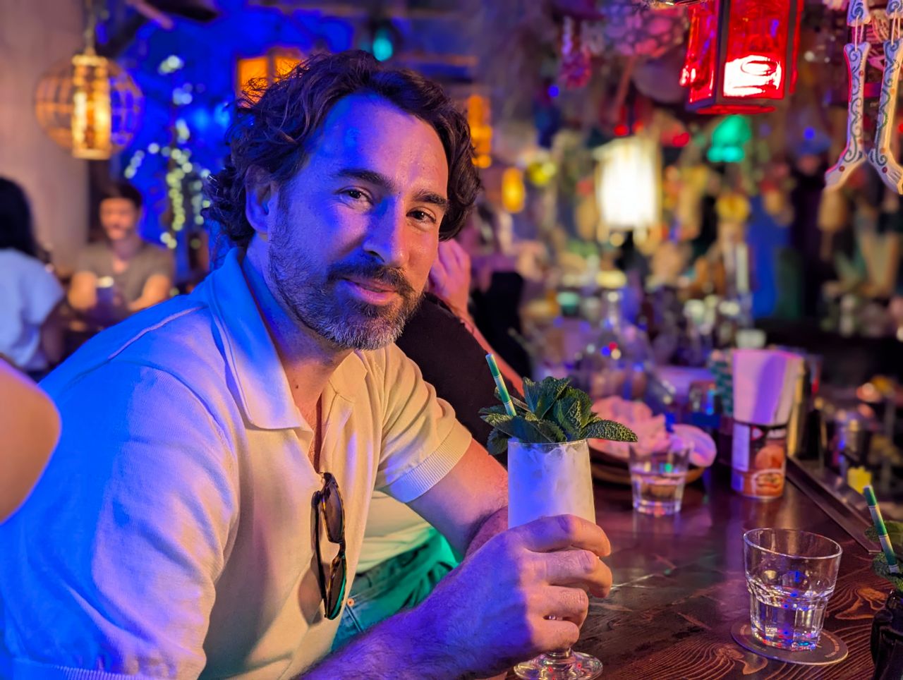 Chef Eric Robertson with a tropical cocktail at the bar inside Hamilton's Maipai