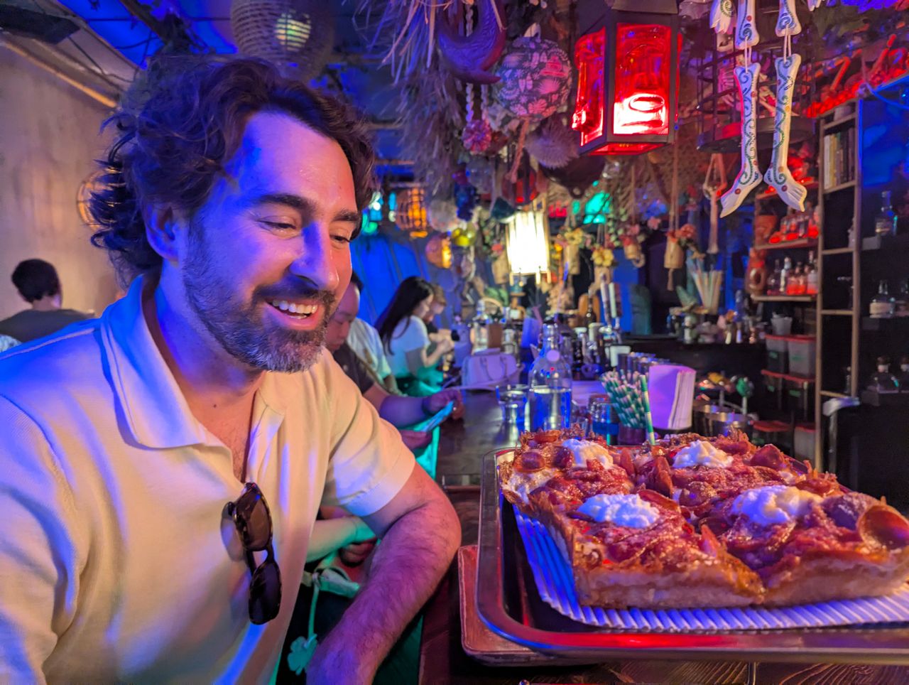 Chef Eric Robertson looks at a pizza at Maipai