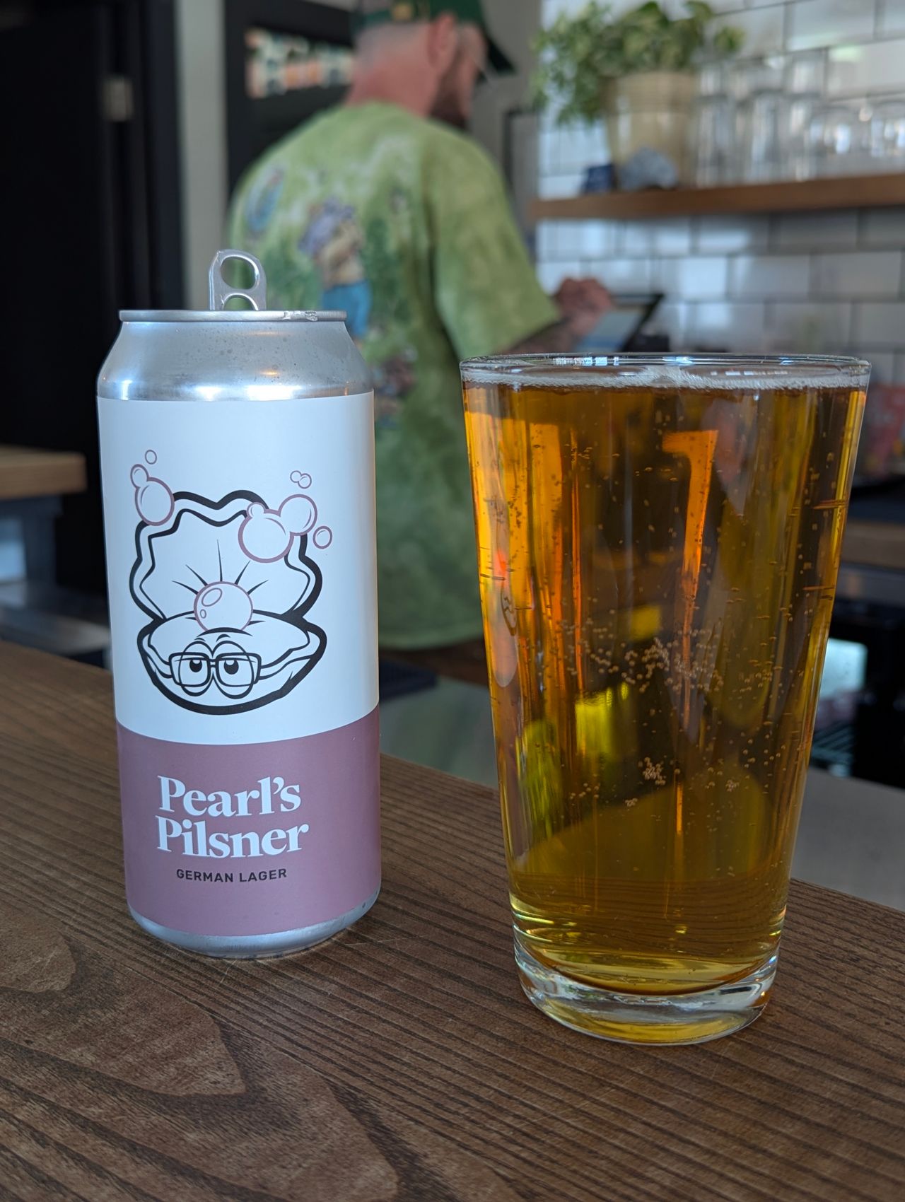 A can of Pearl's Pilsner next to a pint of beer