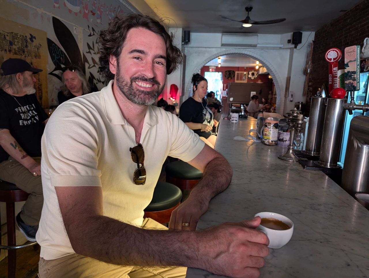 Chef Eric Robertson drinks an espresso at the bar inside the Brain