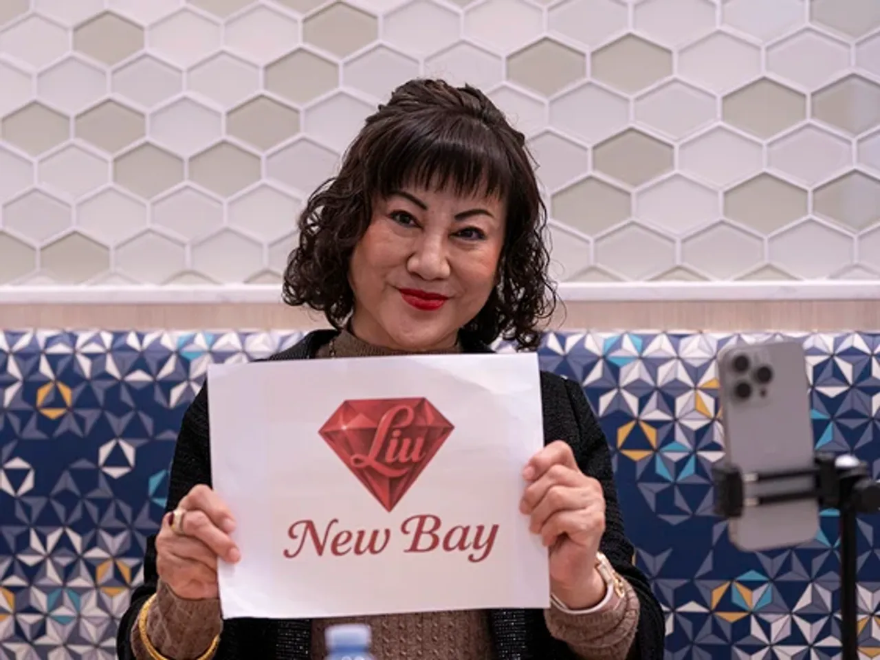 The Chinese billionaire behind the Bay's acquisition says she may move to Toronto