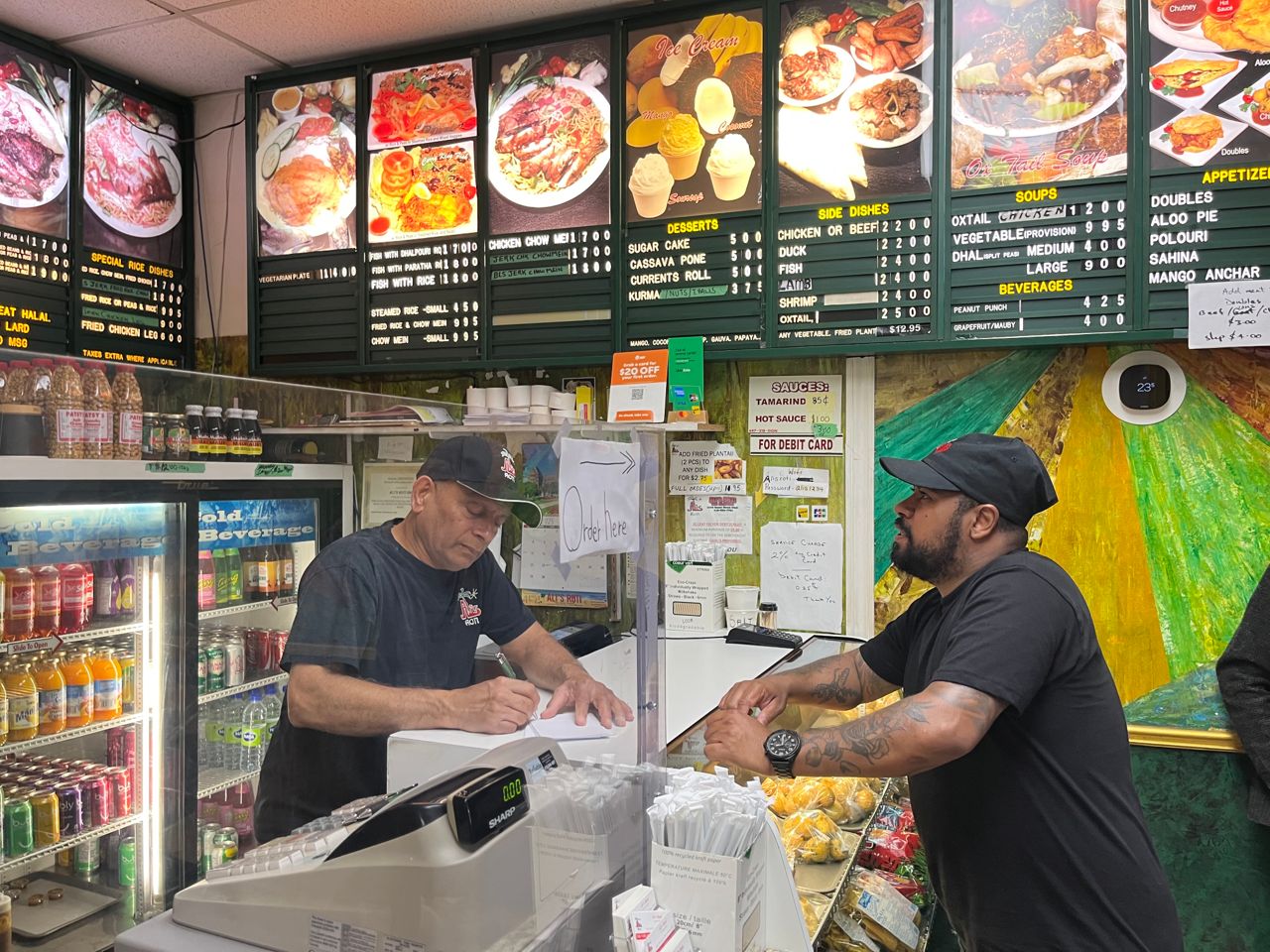 Chef Jerome Robinson places an order at Ali's Roti in Toronto's Parkdale neighbourhood