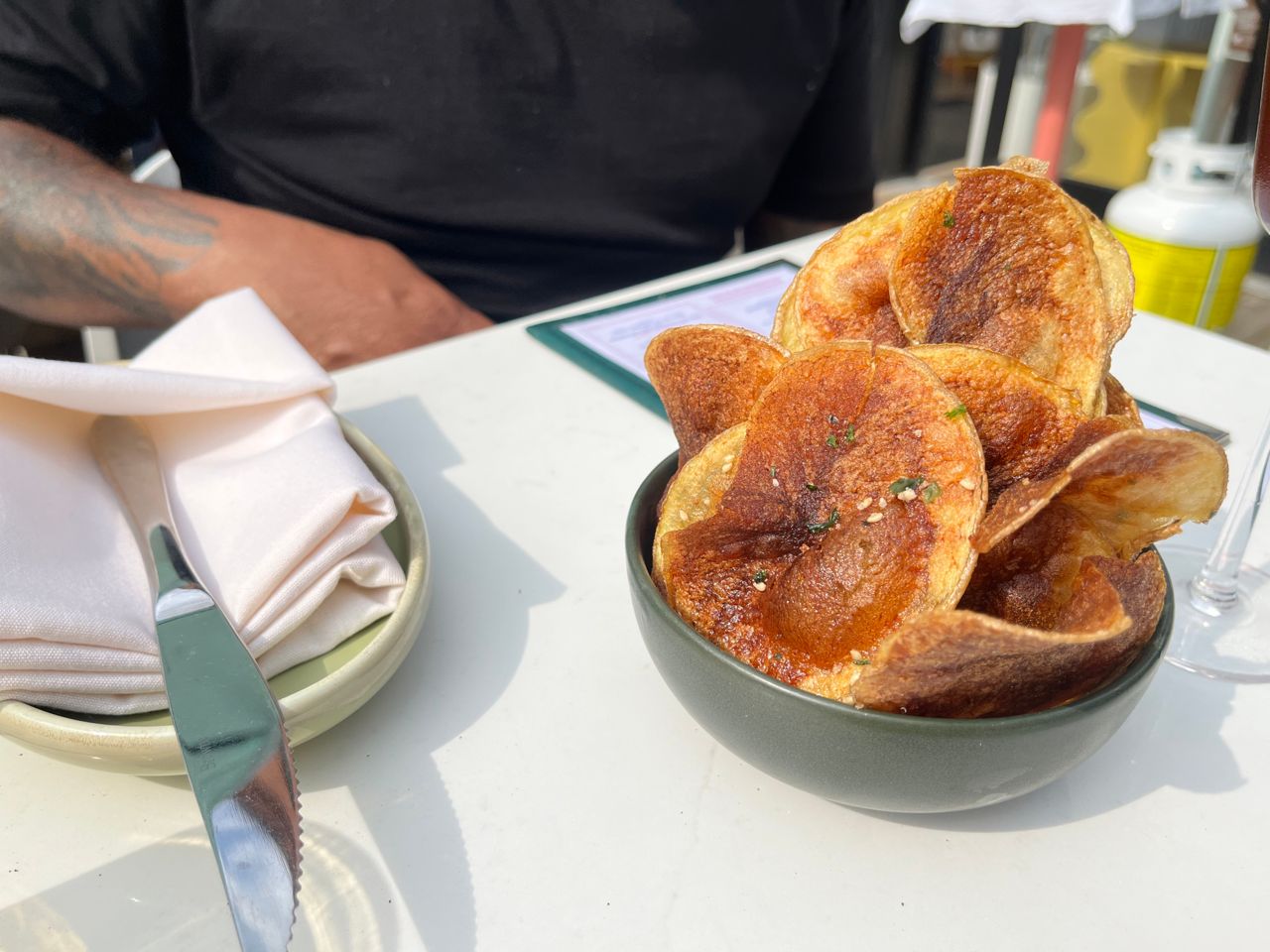 A bowl of house-made potato chips with furikake seasoning