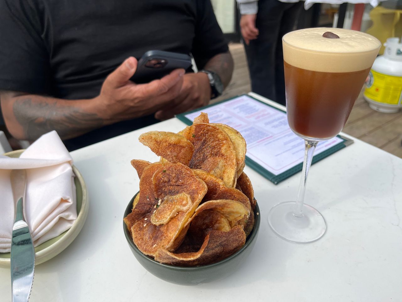 A bowl of house-made potato chips and an espresso martini