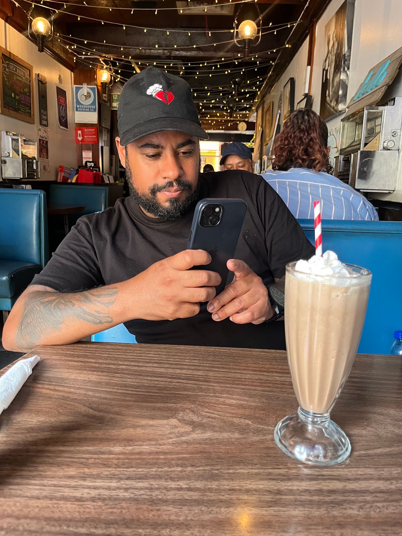 Chef Jerome Robinson uses his phone to take a picture of a chocolate milkshake