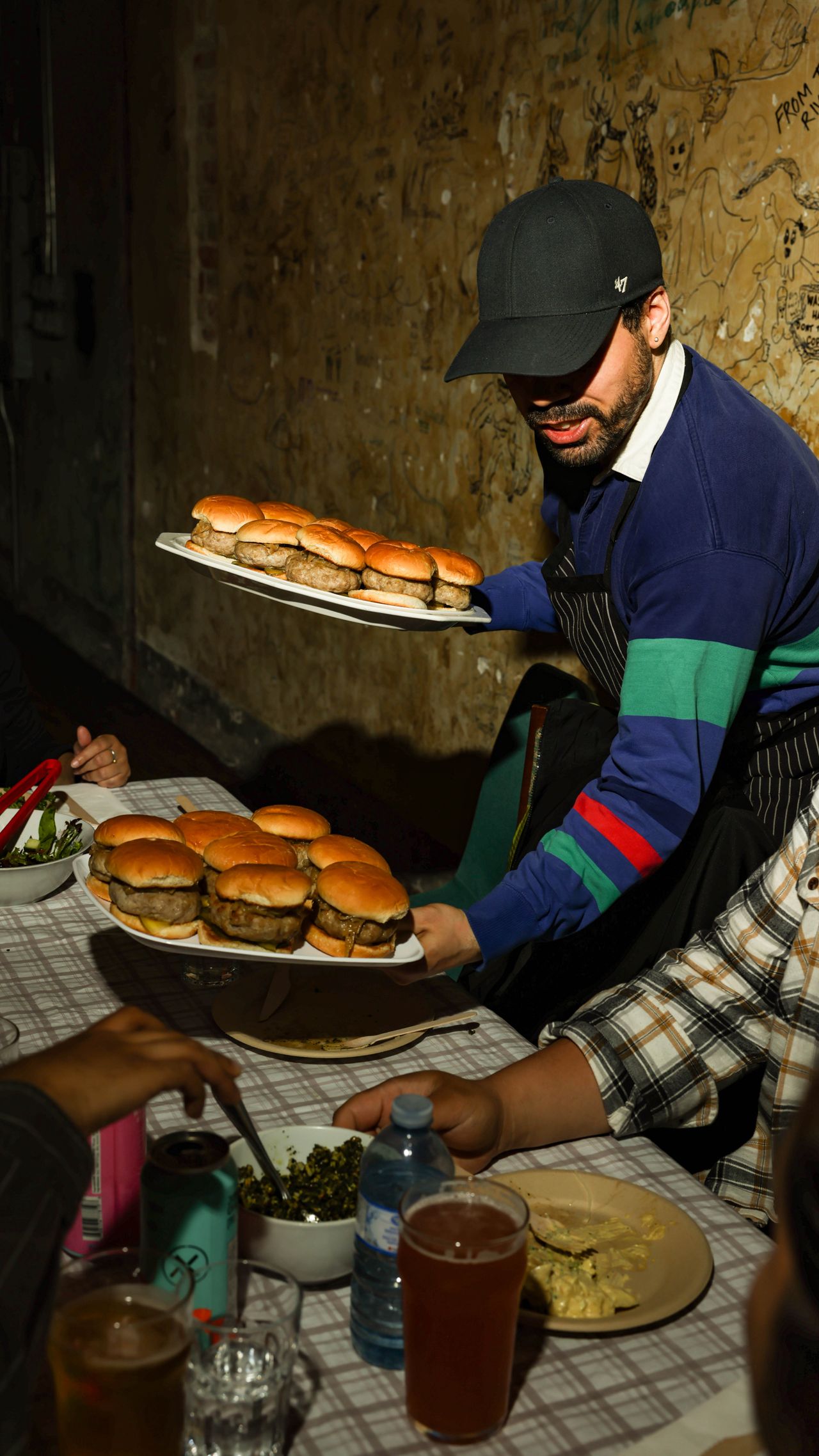 Coire chef Rolando Argueta serves his Sunday supper club guests bratwurst burgers