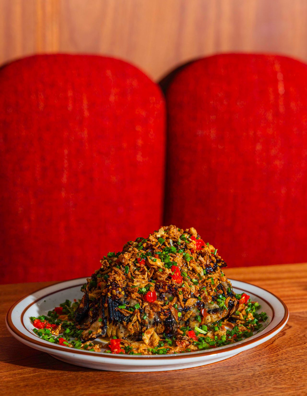 Oven-roasted cabbage dressed with chili crisp, balsamic reduction, a punchy mustard vinaigrette, crispy onions, pickled Anaheim chilies and chives