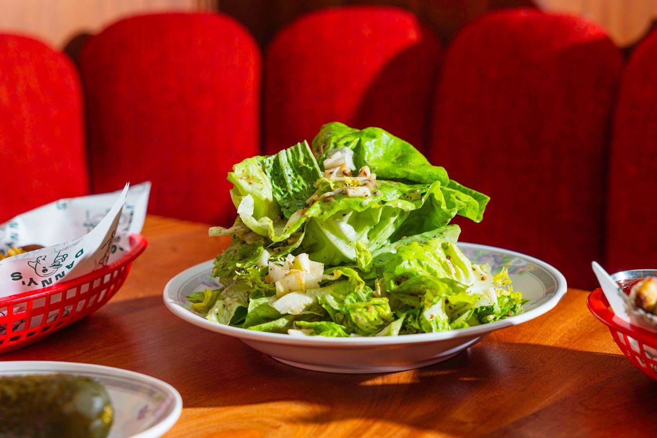 This salad dresses Boston bibb, watercress, romaine, Belgian endive and frisée in a light and tangy mustard vinaigrette of olive oil, shallots, garlic, thyme, sherry vinegar and two types of mustard