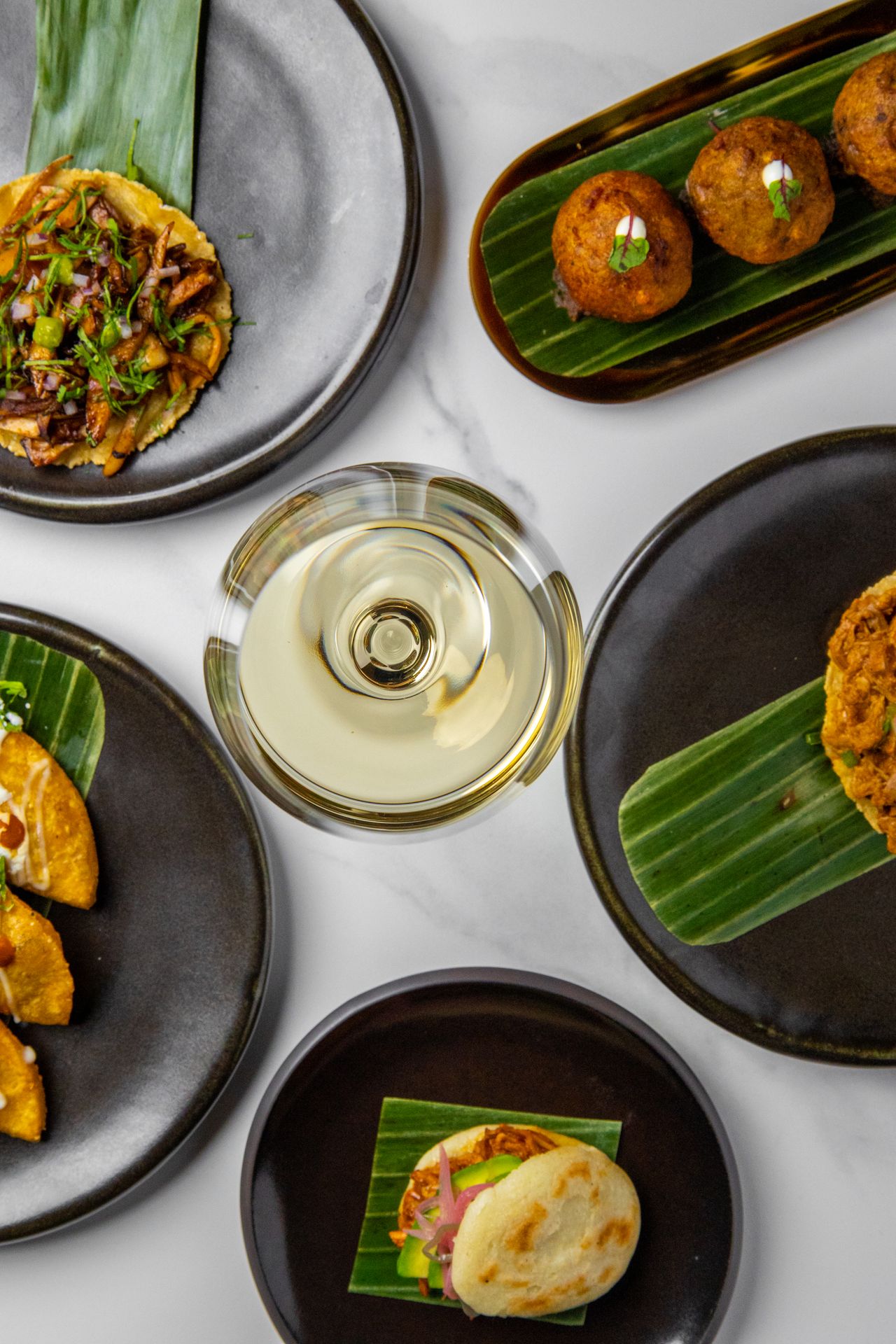 A spread of dishes and drinks at Ficoa in Toronto