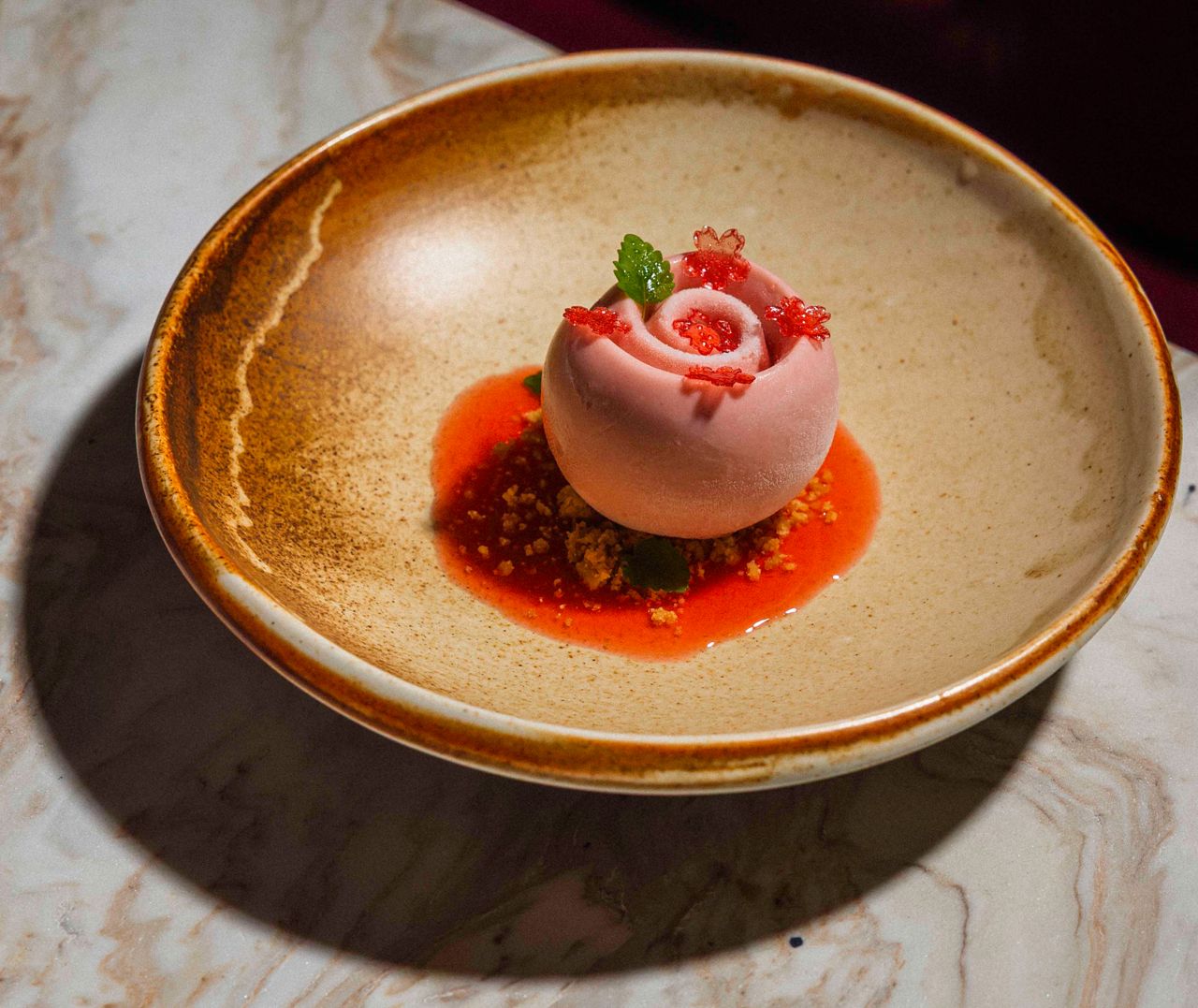 Sinfonia di Fragole, a symphony of strawberry in five movements: a silky panna cotta, piped with jam and sitting in a glossy pool of strawberry glaze
