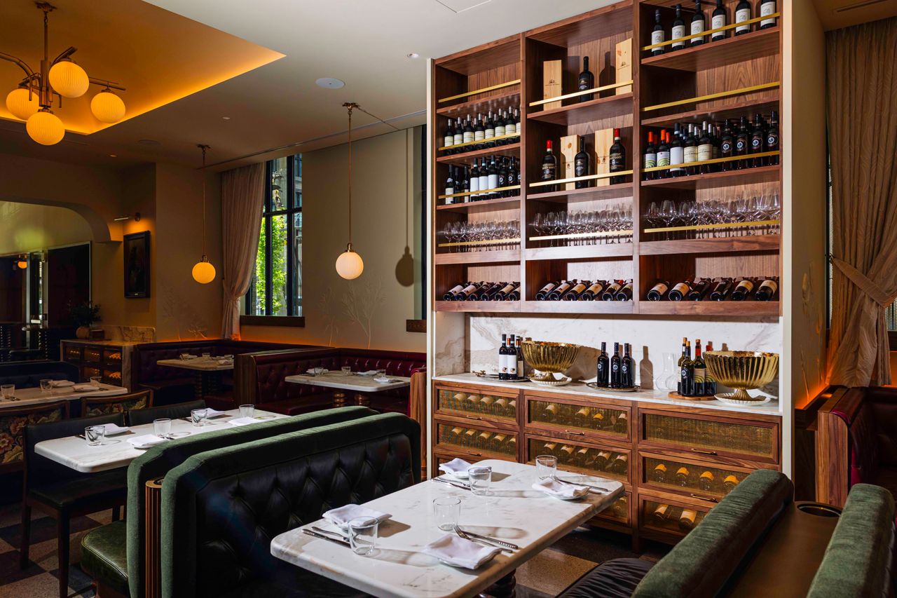 Shelves stocked with wine in the dining room of Florin