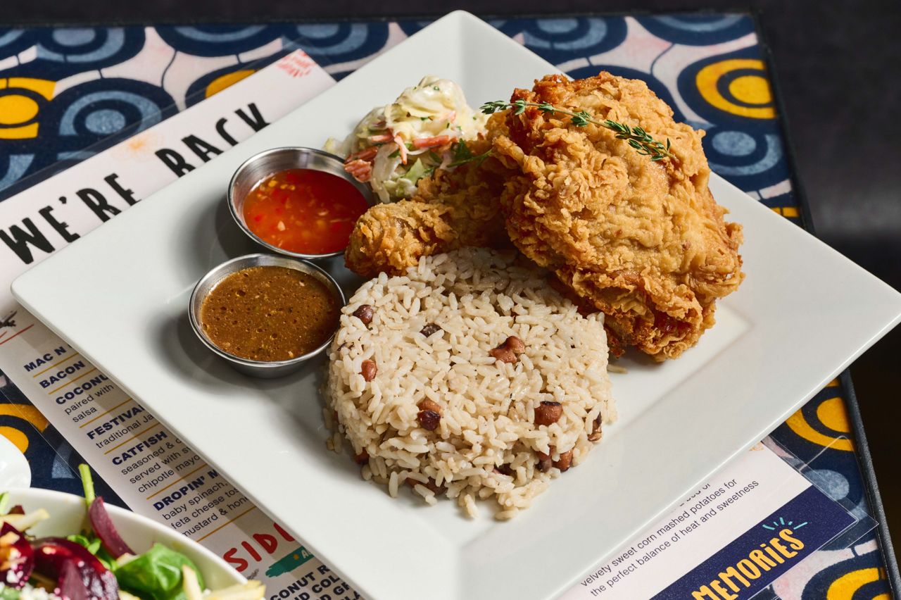 Fried chicken served with coconut rice and peas, coleslaw and a drizzle of house-made gravy and sweet chili sauce