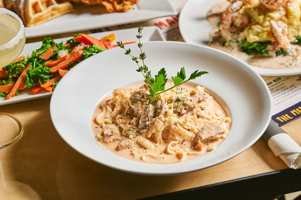 Creamy coconut milk fettuccine with spicy Italian sausage, jerk chicken and the aromatic trio of garlic, onion and white wine