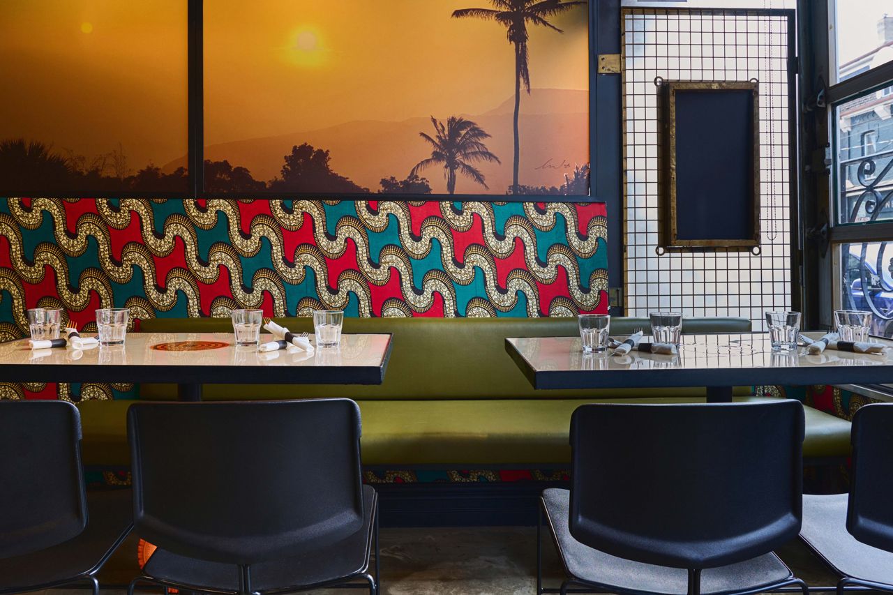 Colourful wallpaper and murals line the walls of Harlem Restaurant's dining room