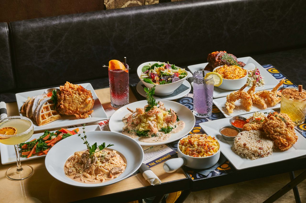 A spread of dishes and drinks at Harlem Restaurant in Toronto