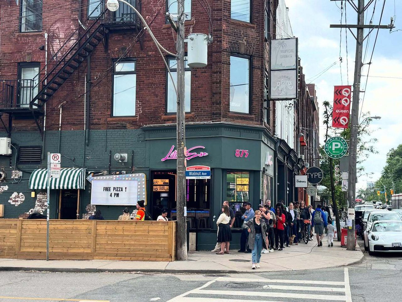 A lineup outside Little Ese, a pizzeria on Queen Street West in Toronto