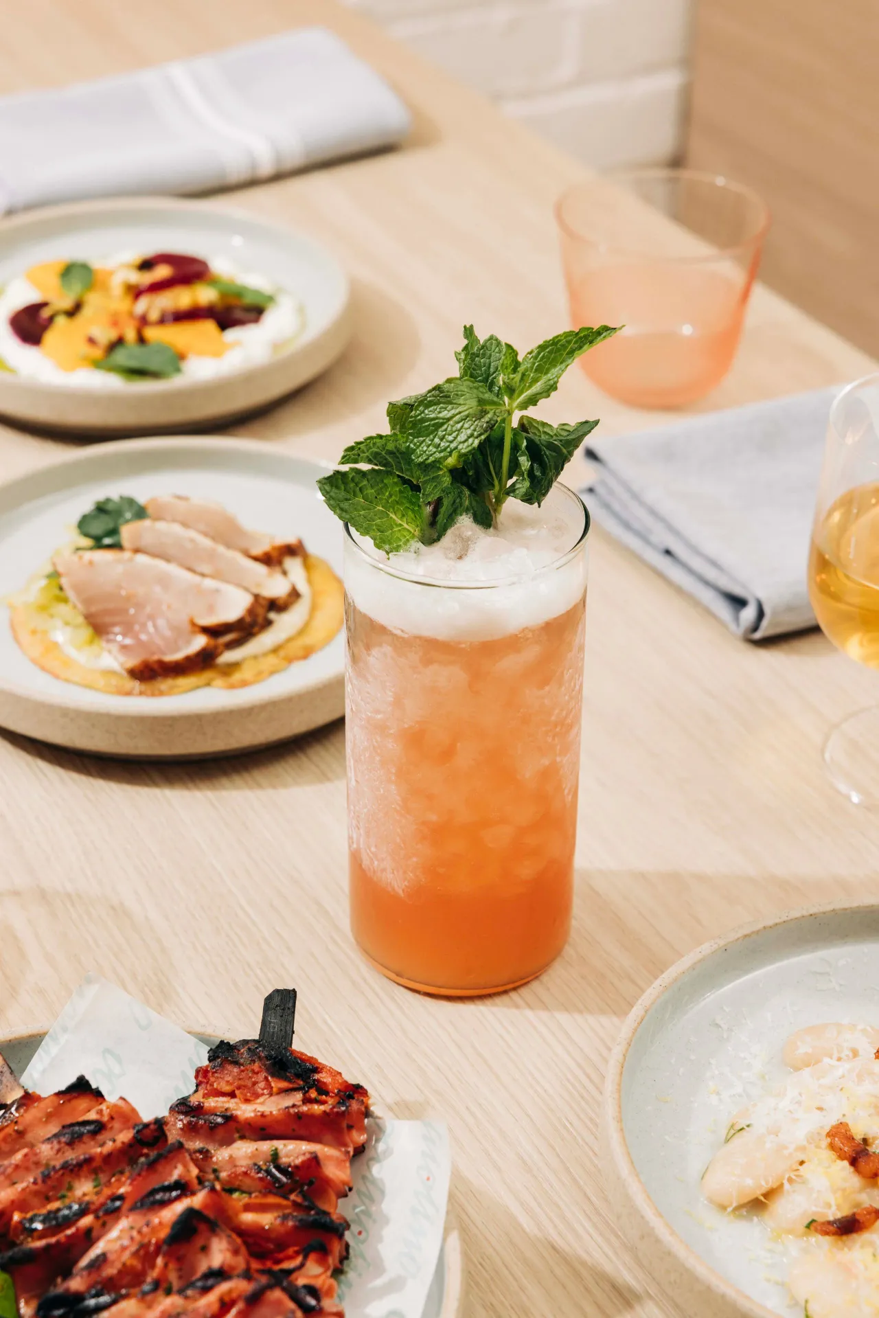 A spread of dishes and drinks at Occhiolino in Toronto
