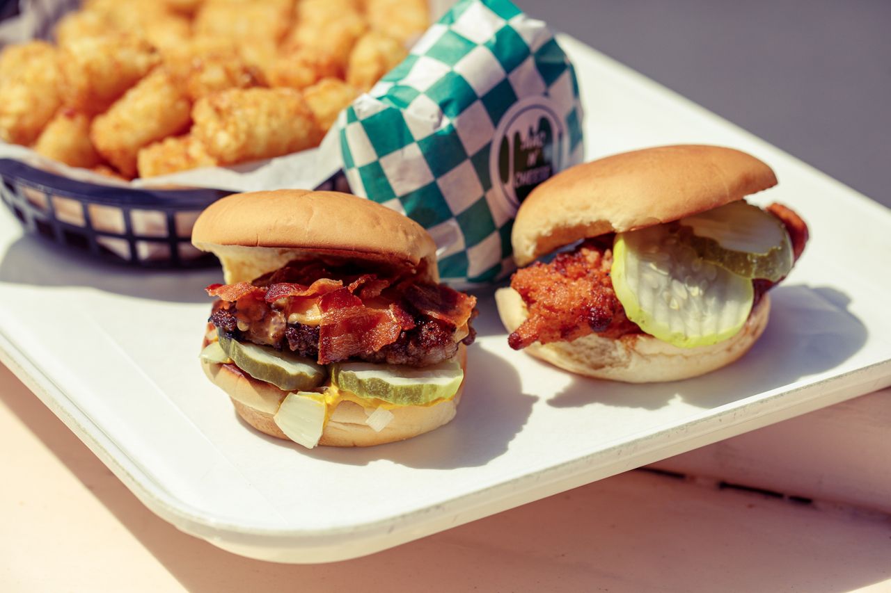 A tray of cheeseburger sliders and tater tots at Pennies in Toronto