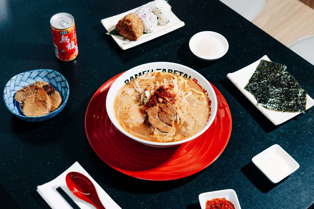 A spread of ramen, onigiri and drinks at Ramen Tabetai