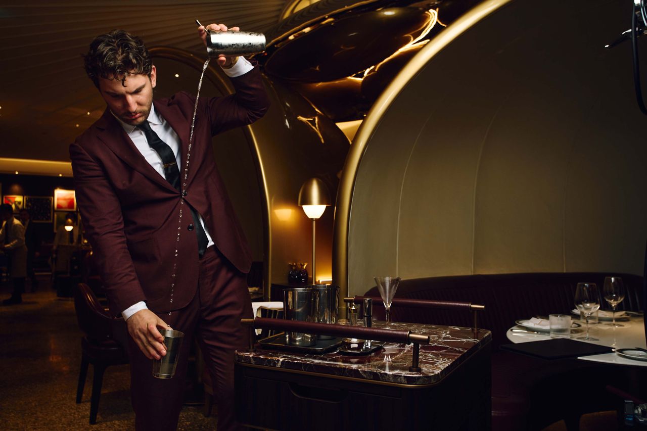 A server pours a martini tableside at Bisteccheria Sammarco in Toronto