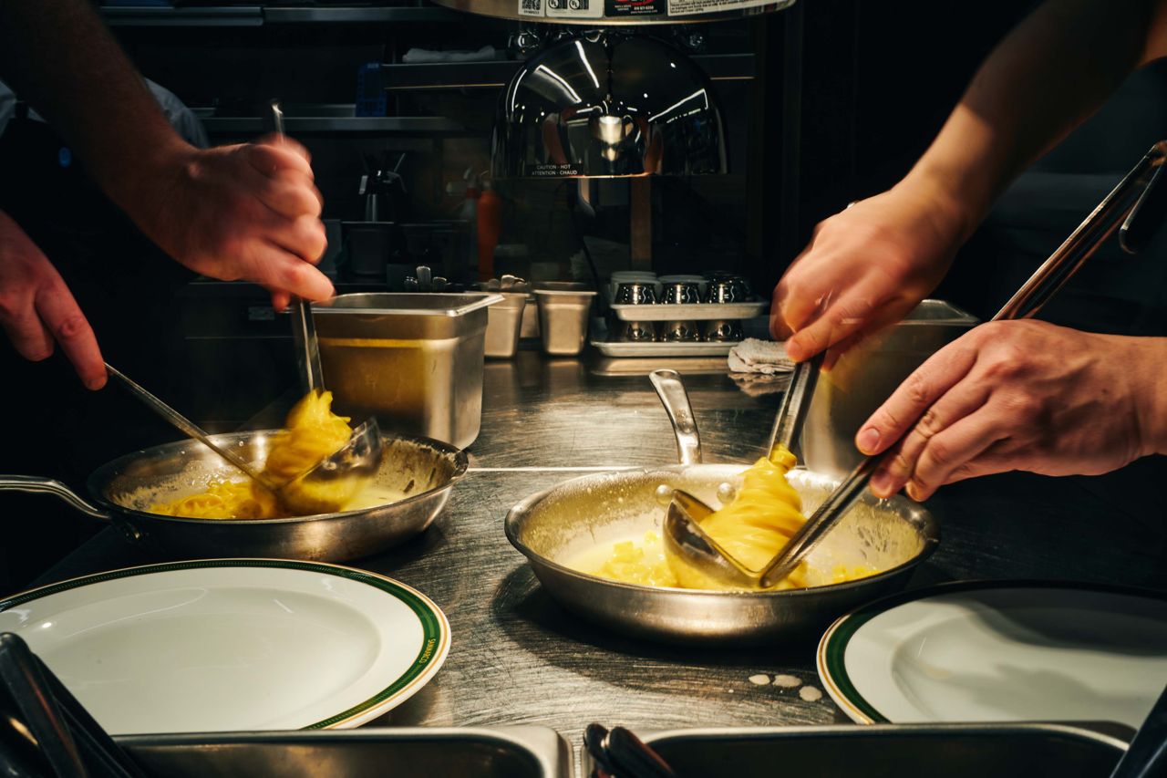 Chefs make pasta in a restaurant kitchen