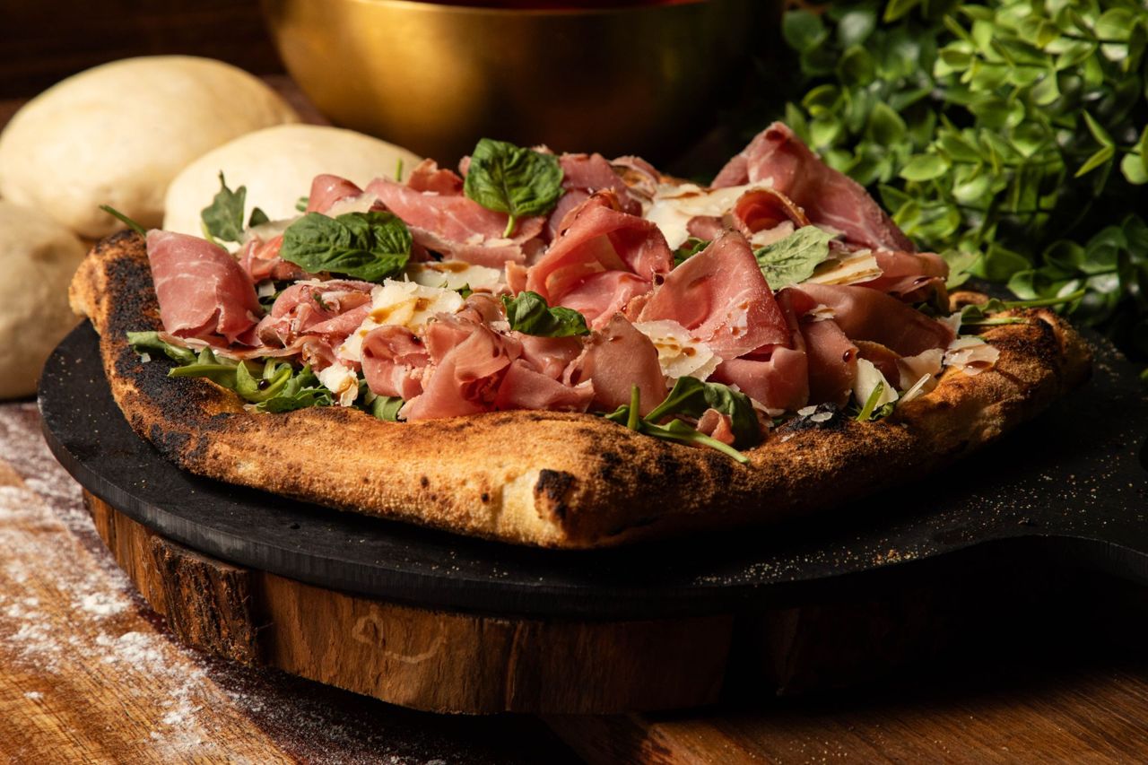 A pizza topped with mortadella