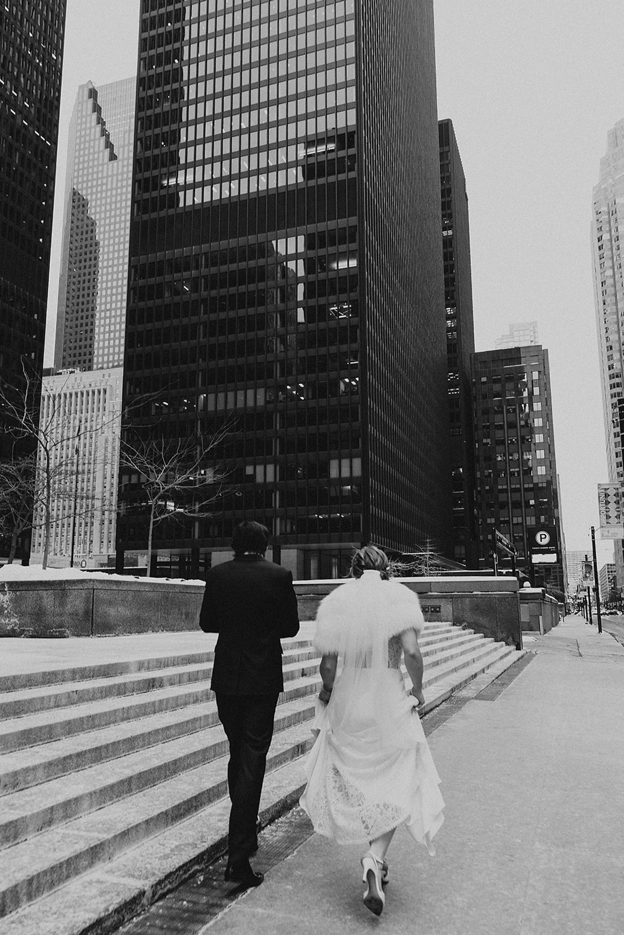 A black and white photo of Caroline and Mauricio walking downtown
