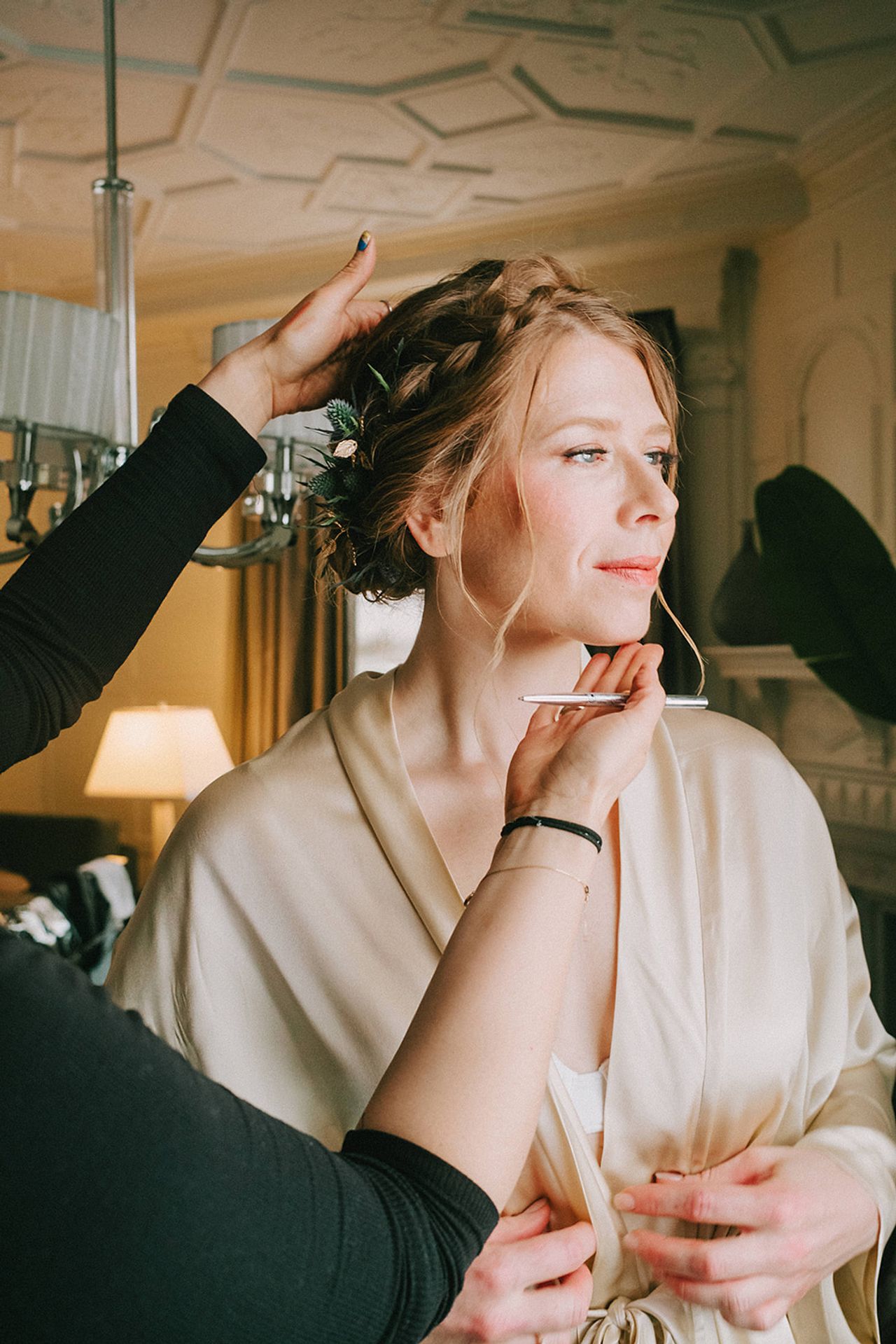 Caroline getting her makeup done before her wedding