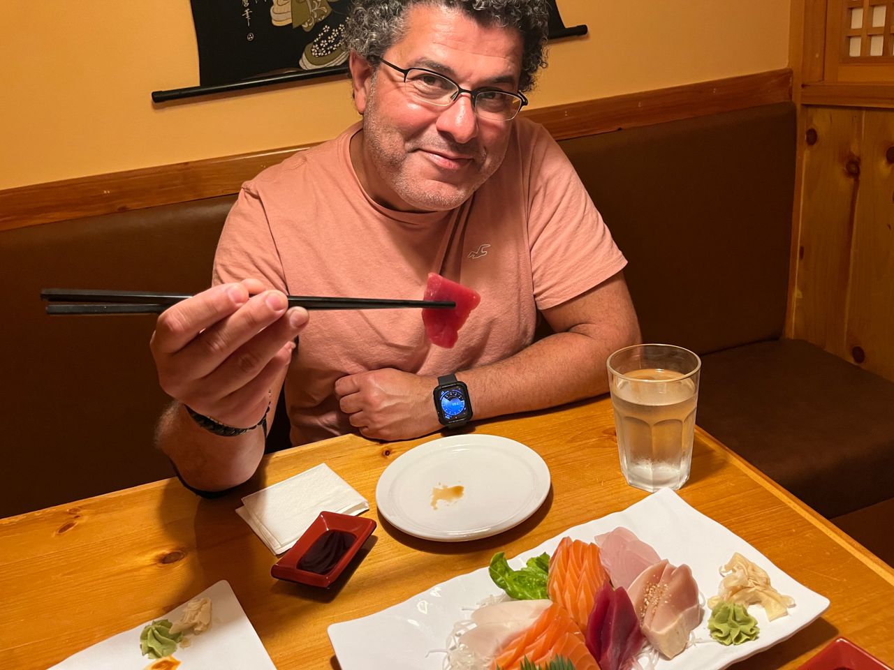 Chef Nizar El Ali uses chopsticks to hold a piece of sashimi
