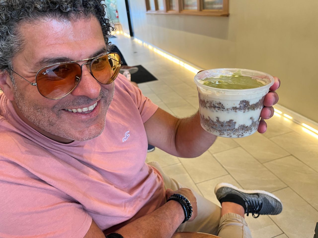 Chef Nizar El Ali holds a takeout container of pistachio areeka