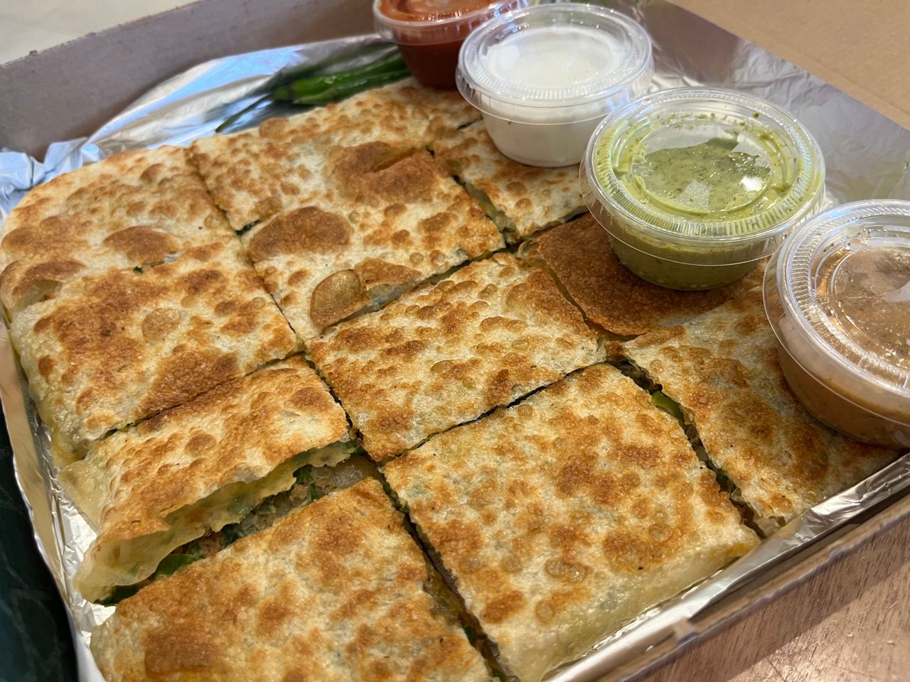 An order of savoury mutabak with four different dips