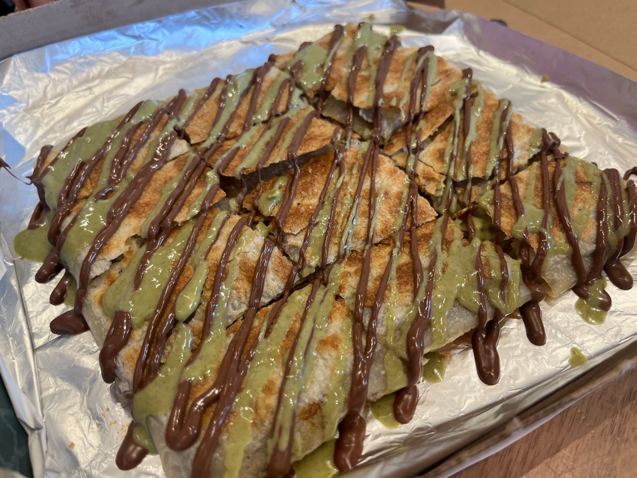 An order of sweet mutabak drizzled with pistachio cream and chocolate