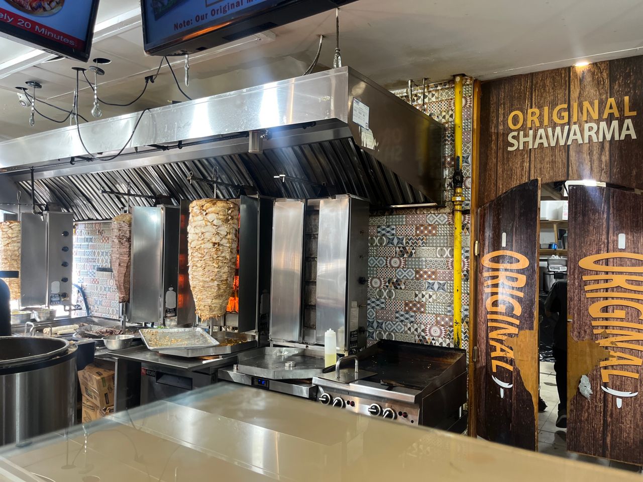 Chicken on a spit behind the counter of Original Shawarma in Mississauga