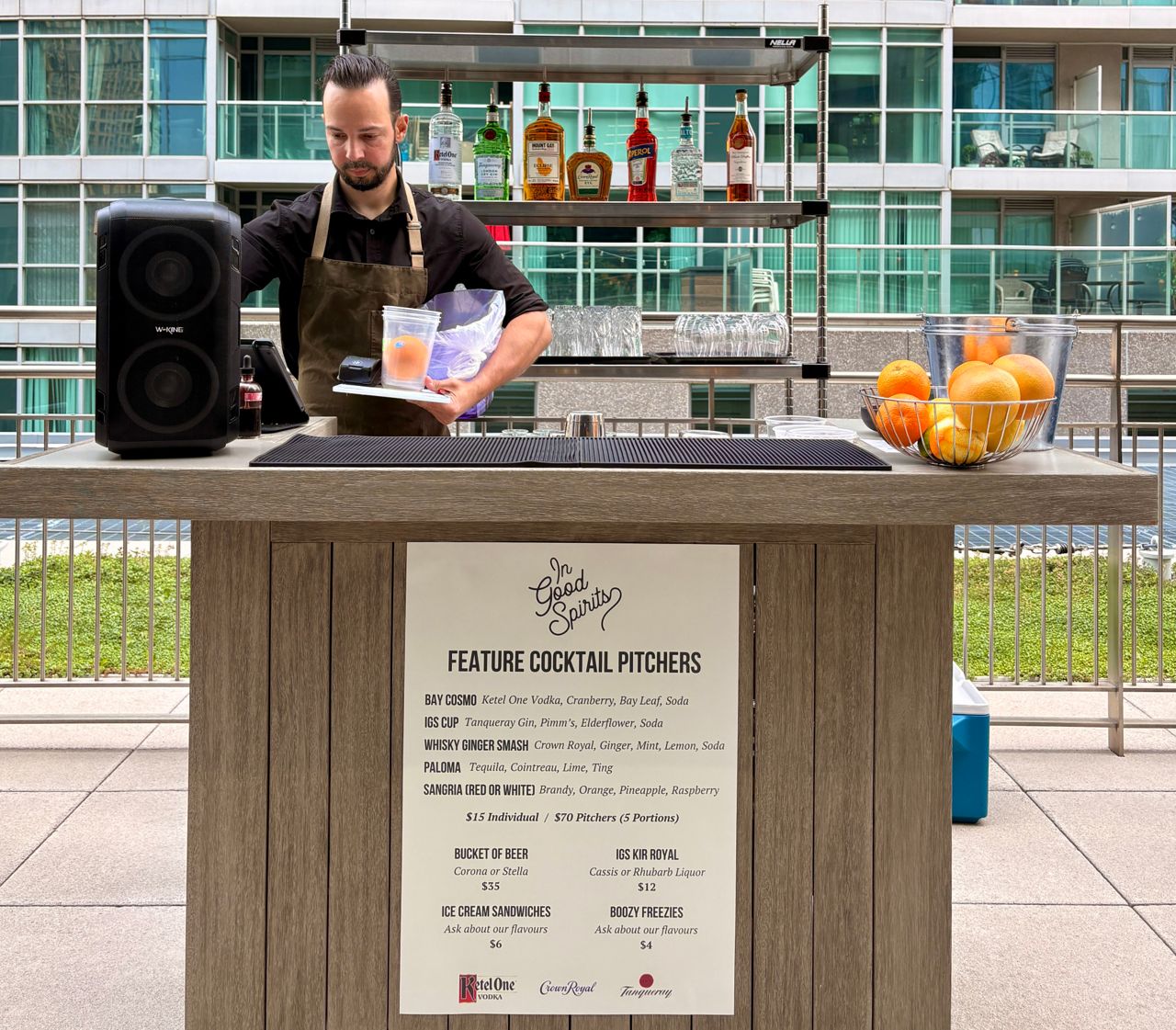 A bartender on the patio at In Good Spirits, a cocktail bar in Toronto's Financial District