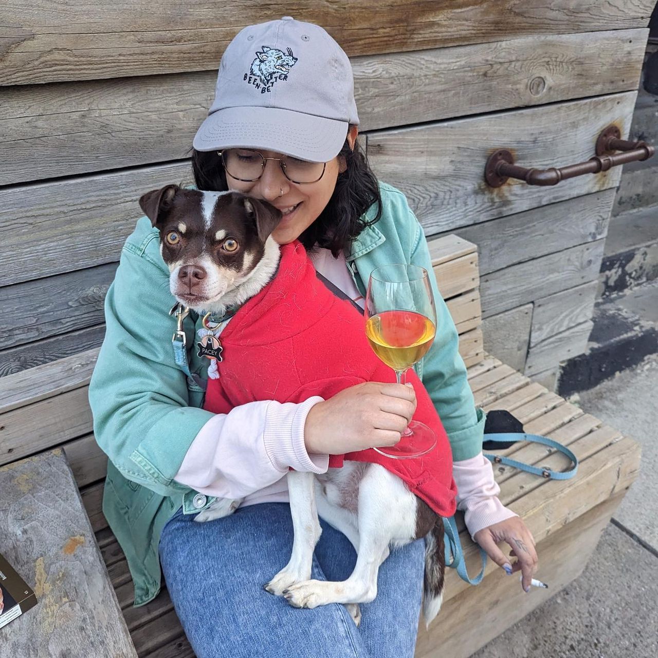 A person holds a dog on the patio at Buvette Pacey