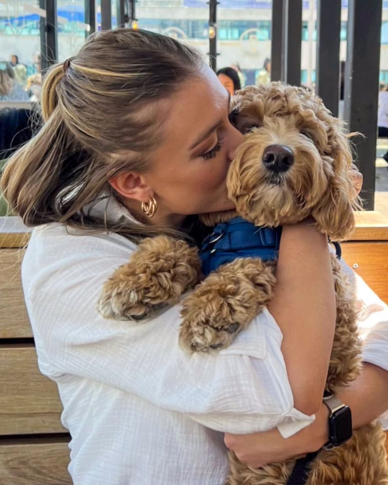 A woman holds a dog on the patio at the Goodman Pub and Kitchen